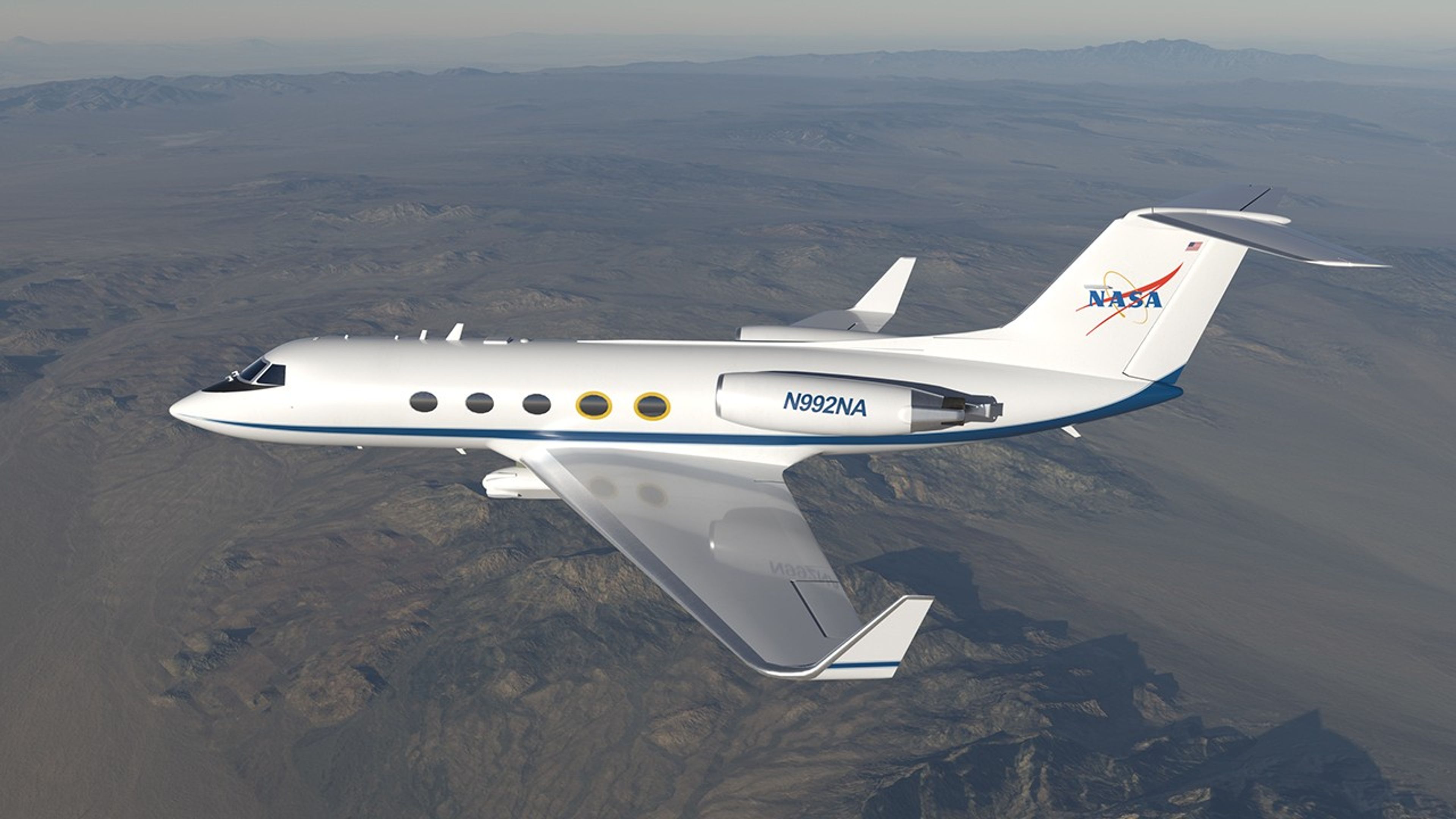 A white NASA research aircraft with blue accents and the NASA logo on its tail is flying over a rugged, mountainous desert landscape under clear skies. Image description: A NASA research aircraft flies over a desert landscape with mountains in the distance. The white plane has blue accents and the NASA logo on its tail, with circular observation windows along the fuselage.